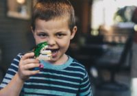 little boy holding mock up jaws