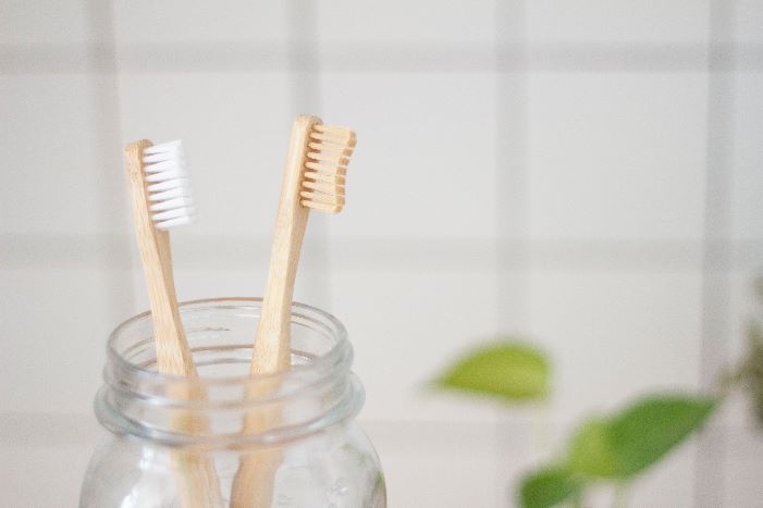 two brown wooden toothbrushes