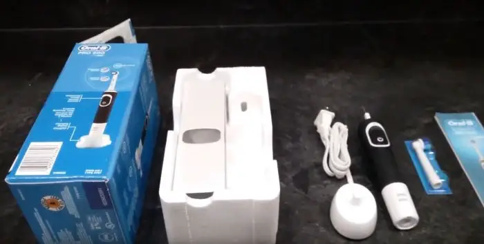 oral b 500 electric toothbrush box contents - retail box, internal packaging, charger, toothbrush, brush head, and user manual