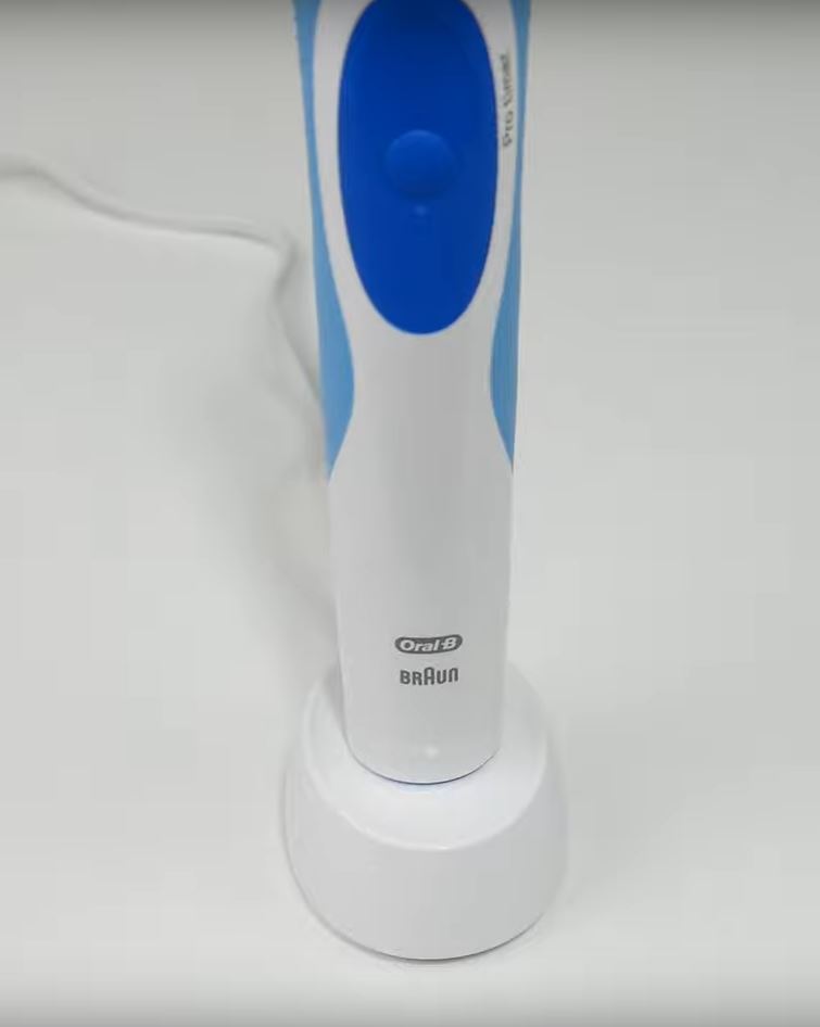 white and blue oral-b pro 500 on the table