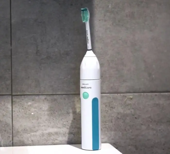 philips sonicare essence sonic electric rechargeable toothbrush, white and blue on bathroom sink