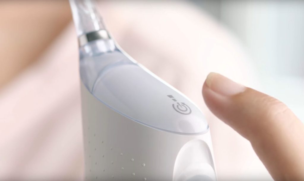 female hand holding Philips Sonicare Airfloss Ultra flosser