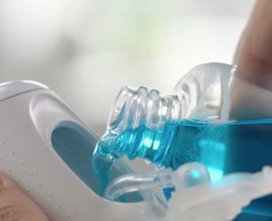 filling in mouthwash in Sonicare Airfloss